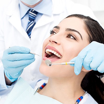 patient visiting dentist for checkup and cleaning