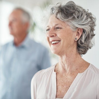 Woman with all on four dental implants sharing beautiful smile