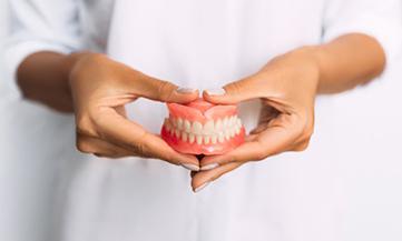 Lady presents viewer with dentures?
