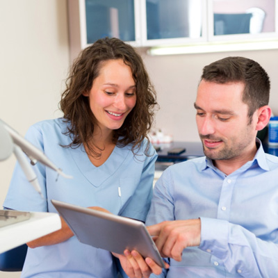 Patient looking at Smile Design with team member 