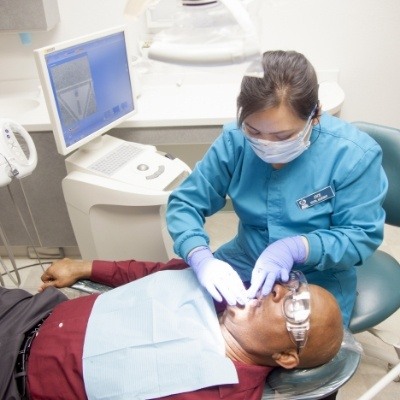 Dentist performing dental implant salvage treatment