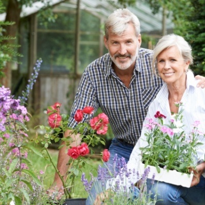 Smiling man and woman with implant dentures