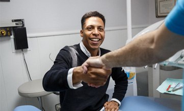 Man shaking dentist's hand after Invisalign in Chesapeake Virginia