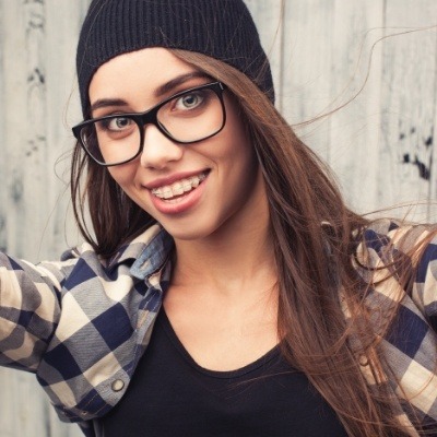 Smiling young woman with Invisalign aligners in place