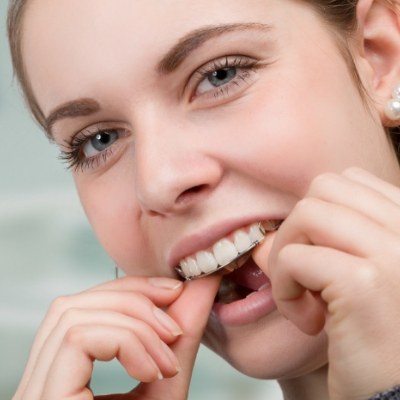 Woman changing Invisalign aligner