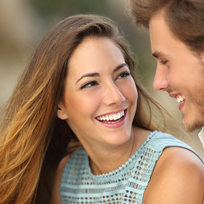 Woman smiling with man after Invisalign treatment in Chesapeake Virginia