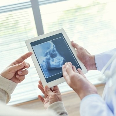 Dentists looking at digital x-rays during preventive dentistry checkup and teeth cleaning visit