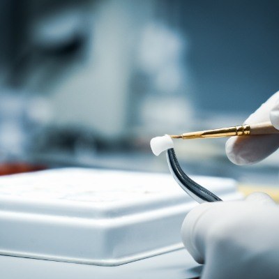 Lab technician crating a dental crown restoration