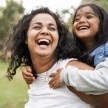 Mother and child laughing together after children's dentistry visit