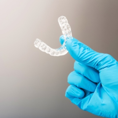 Hand holding an occlusal splint for T M J dysfunction