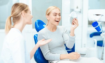 woman talking to dentist about cost of veneers in Chesapeake
