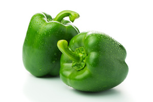 Close-up of two large green bell peppers