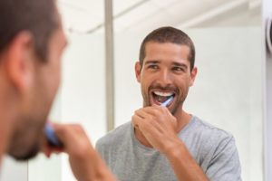 a man brushing his teeth