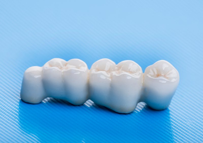 A complete dental bridge sitting on a table
