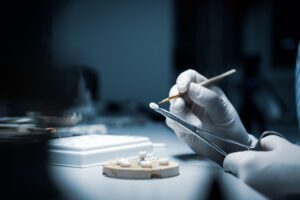 Lab tech creating dental crowns