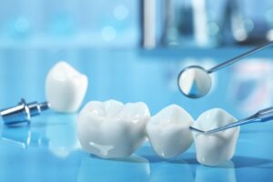 Dental crowns with dental instruments shown.