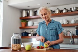 Woman with all-on-4 implants preparing food